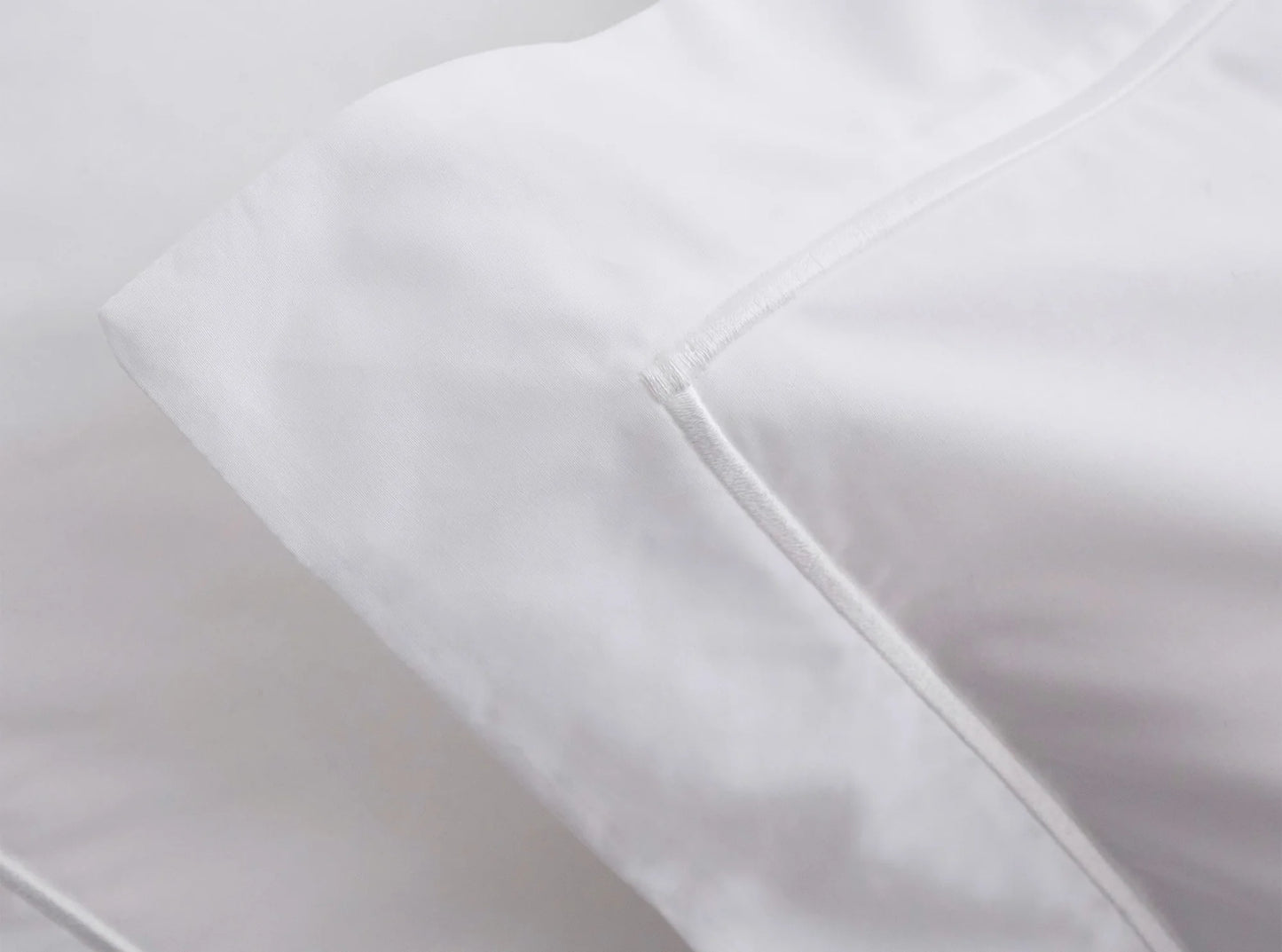 Embroidered edge detail on organic percale duvet cover in white - handcrafted in Portugal