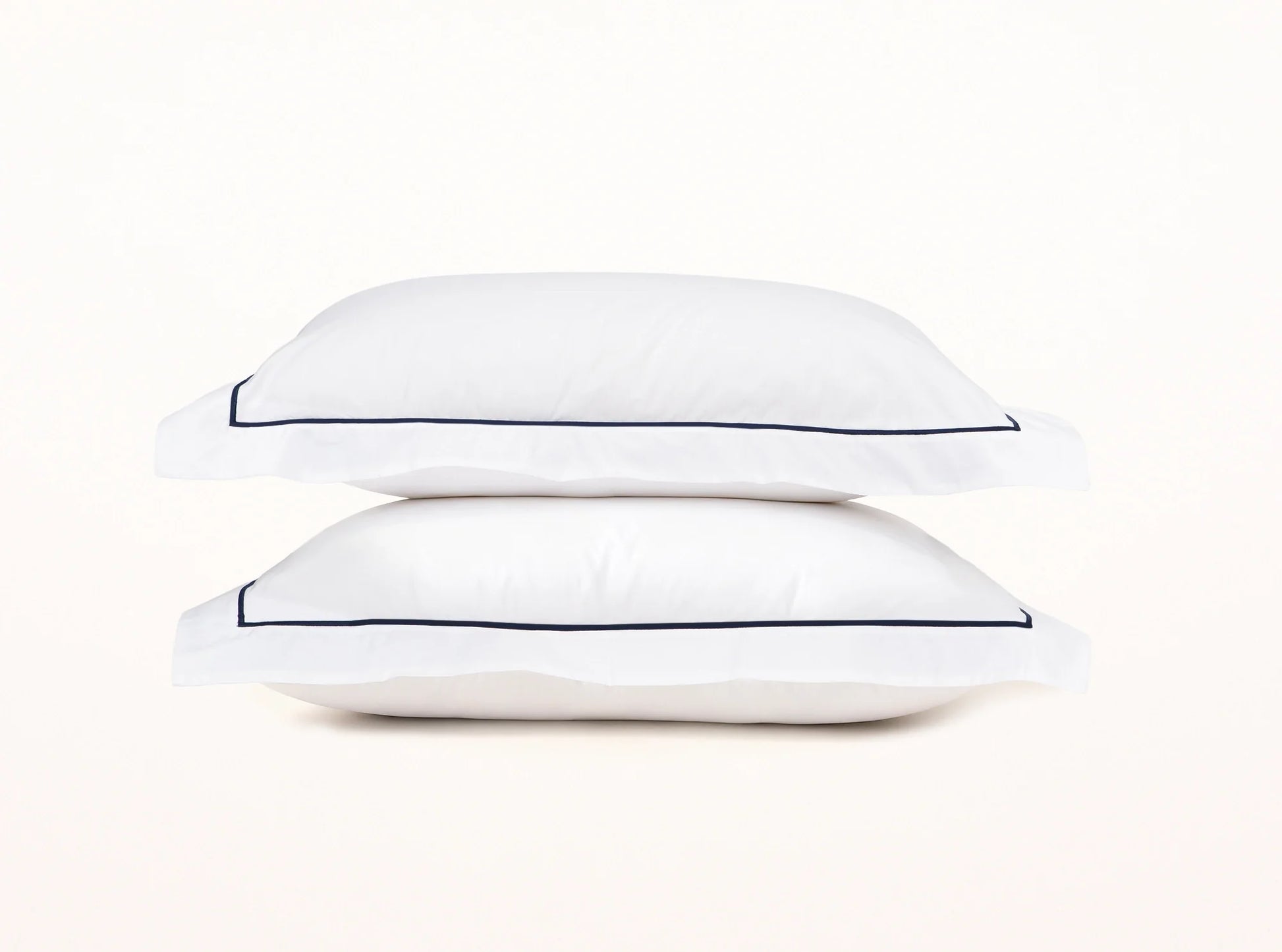 White organic percale duvet cover shams with navy blue embroidered detail - elegant contrast