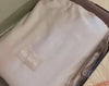 Customer unboxing and reviewing the luxury gray sateen hemstitched organic cotton sheets, highlighting softness, comfort, and eco-friendly materials.